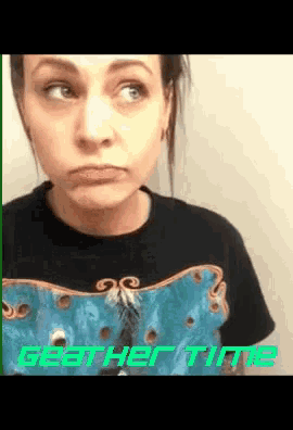 a woman wearing a black shirt with the words get her time on the bottom right