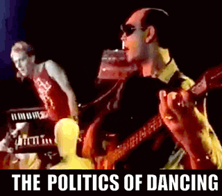 a man is playing a guitar in a band with the words the politics of dancing above him