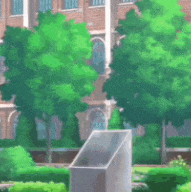 a brick building with a lot of green trees and bushes in front of it