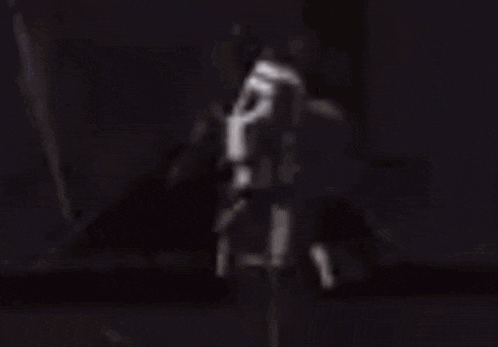 a blurry picture of a person standing on the side of a road in a video game .