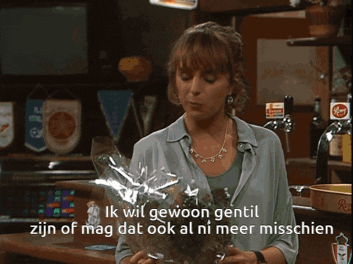 a woman is holding a bouquet of flowers and says ik wil gewoon gentil