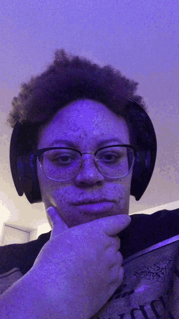 a person with freckles wearing headphones and a t-shirt that says ' i love you ' on it