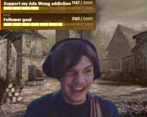 a man wearing headphones is laughing in front of a screen that says support my ada wong addiction