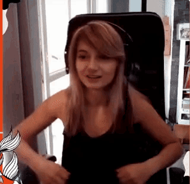 a woman is sitting in a chair wearing headphones