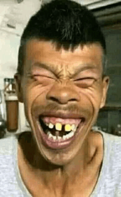 a man with a beard is making a funny face with his eyes closed and his mouth open .