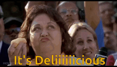 a woman eating a hamburger with the words it 's deliiiilicious written in yellow