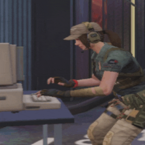 a woman wearing a hat and headphones looks at a computer screen