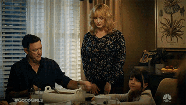 a family sitting at a table with #goodgirls written on the bottom of the screen