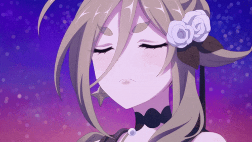 a girl with a flower in her hair looks down at something