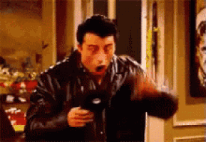 a man in a leather jacket is blow drying his hair with a hair dryer