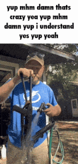 a man in a blue shirt is holding a gun