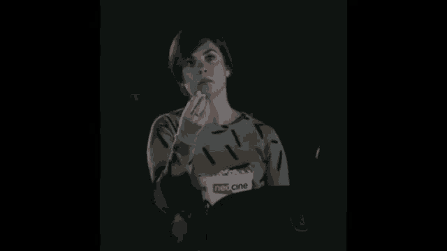 a woman is eating popcorn while watching a movie in a neo cine theater