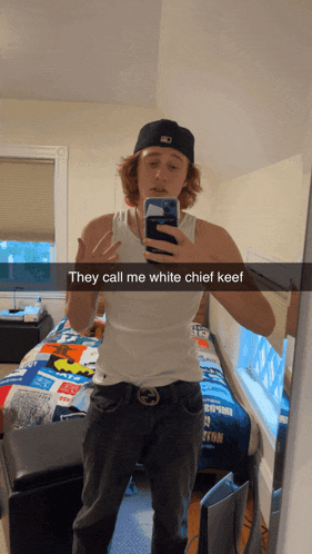 a man taking a selfie in front of a mirror with a caption that says they call me white chief keef