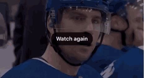 a close up of a hockey player wearing a helmet and goggles making a funny face .