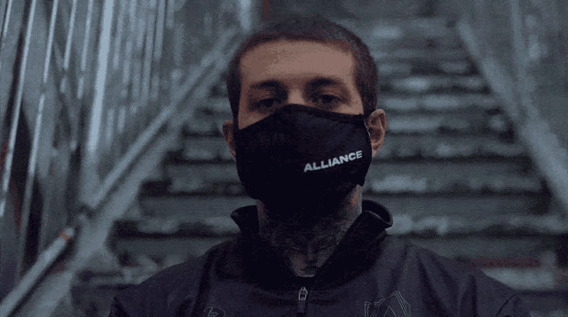 a man wearing a face mask that says alliance on it