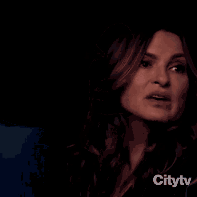 a woman in a blue suit is talking to a man in a suit in a citytv ad
