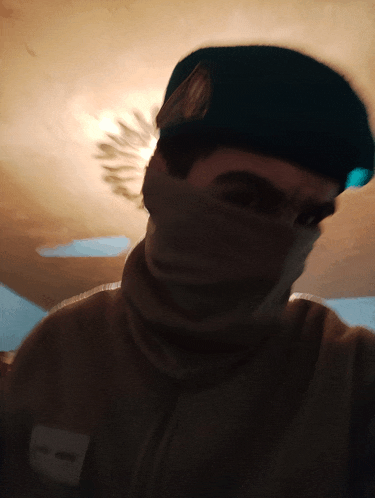 a man wearing a beret and a scarf has a name tag that says ' alonso ' on it