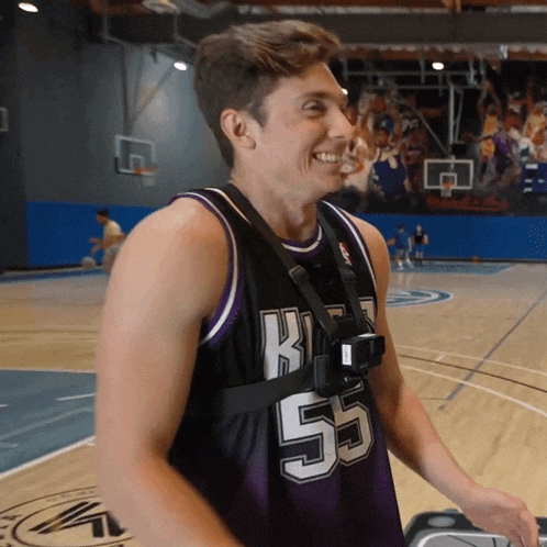 a man wearing a basketball jersey with the number 55 on it is smiling