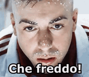 a man with snow on his face and the words che freddo !