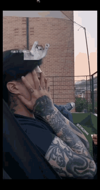 a man with a crown on his head has a tattoo that says ' a ' on it