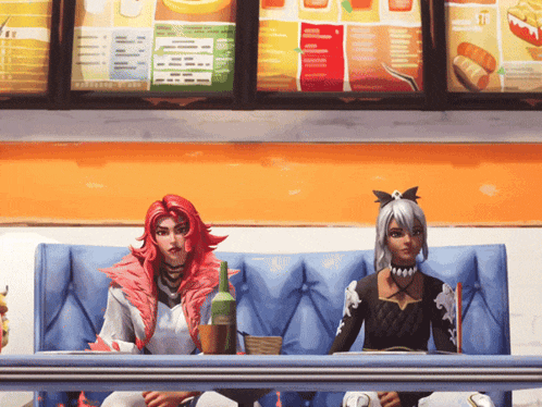 two girls sit at a table in front of a menu