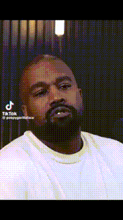 a man with a beard is wearing a white shirt and making a funny face with his mouth open .