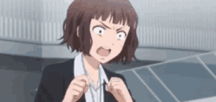 a girl in a suit and tie is making a funny face while standing in front of a building .