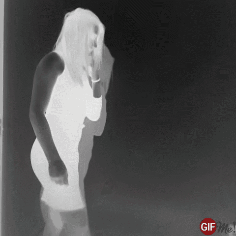 a woman in a white dress is dancing in a black and white photo