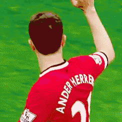 a soccer player wearing a red jersey with the name anderherro on the back