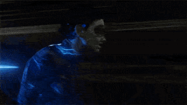 a blurry picture of a person 's face with a blue light behind them
