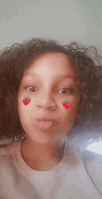 a young girl with strawberries on her face