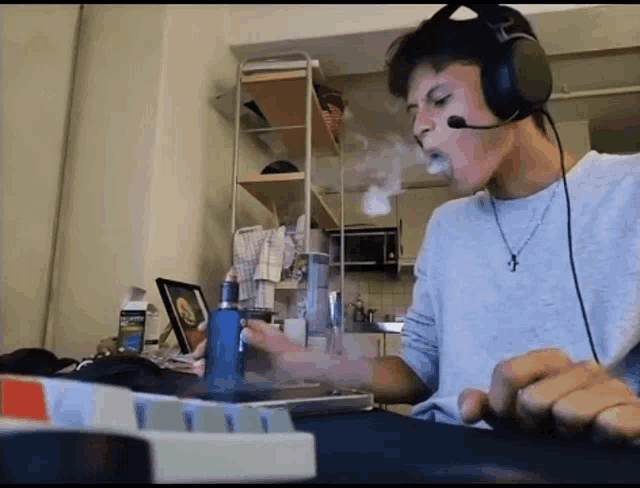 a man wearing headphones is smoking a cigarette
