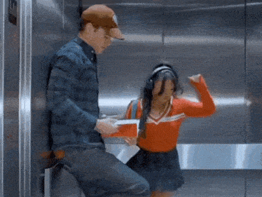 a man and a woman are standing in an elevator with the number 10 on the wall