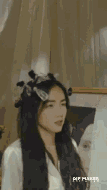 a woman with long hair is standing in front of a mirror .