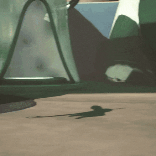 a cartoon character is laying on the ground in front of a green vehicle