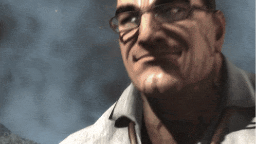 a man wearing glasses and a white shirt smiles for the camera