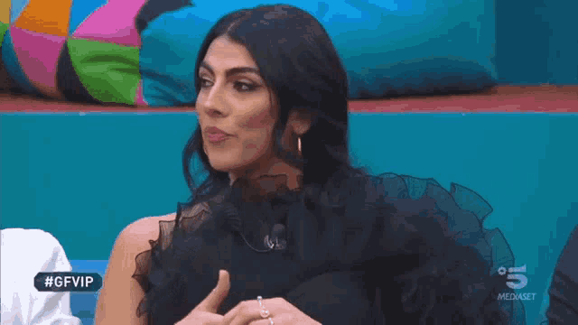 a woman in a black dress is on a tv show called gf vip