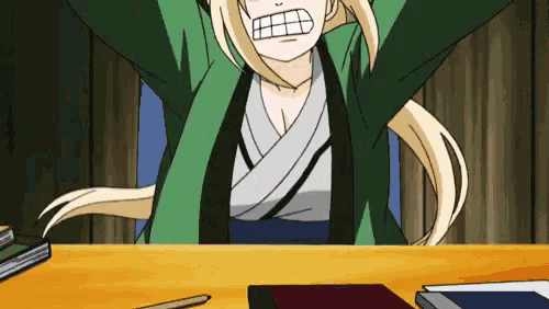 a woman in a green jacket is sitting at a desk with her arms outstretched .