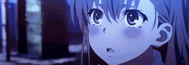 a close up of a girl 's face with tears running down her cheeks