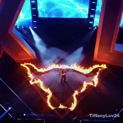 a man stands on a stage surrounded by flames and says tiffanyluv24