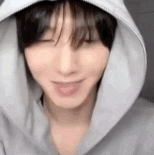 a close up of a person wearing a hooded sweatshirt .