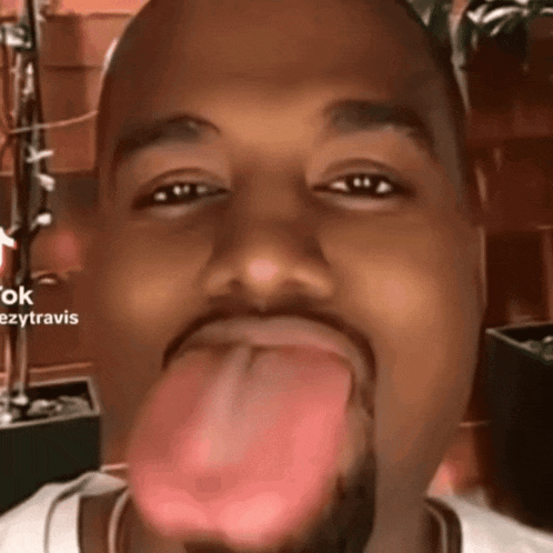 a close up of a man 's face with his tongue hanging out and the words ezytravis on the bottom