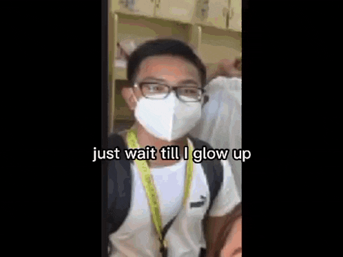 a man wearing a mask and glasses is standing next to a woman and says `` just wait till i glow up '' .