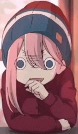 a girl with pink hair is wearing a red sweater and a blue hat .