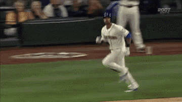 a baseball player is running on a baseball field .