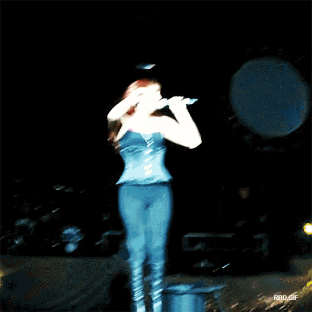 a woman singing on a stage in front of a drum set that says rsd