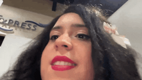 a close up of a woman 's face with express written in the background