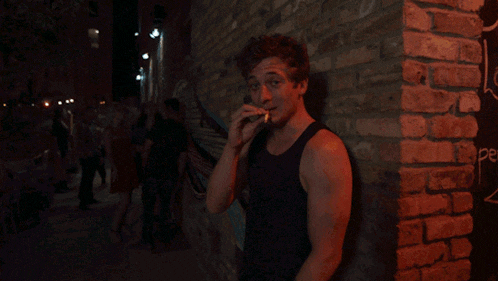 a blurry photo of a man in front of a brick wall