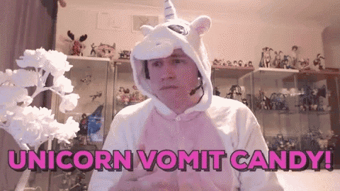 a man in a unicorn costume says unicorn vomit candy in pink letters