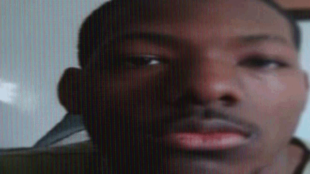 a close up of a man 's face on a screen .